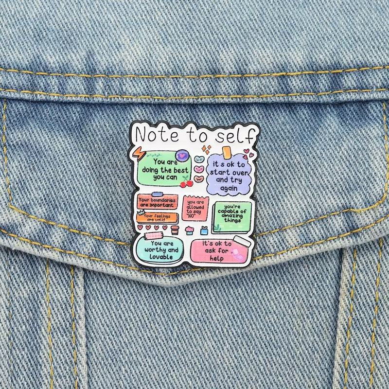 Note to Self affirmation pin displayed on denim