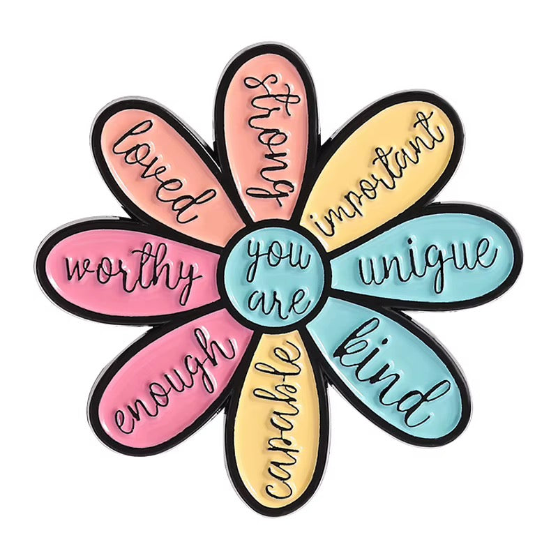 Close-up of colorful You Are flower affirmation pin